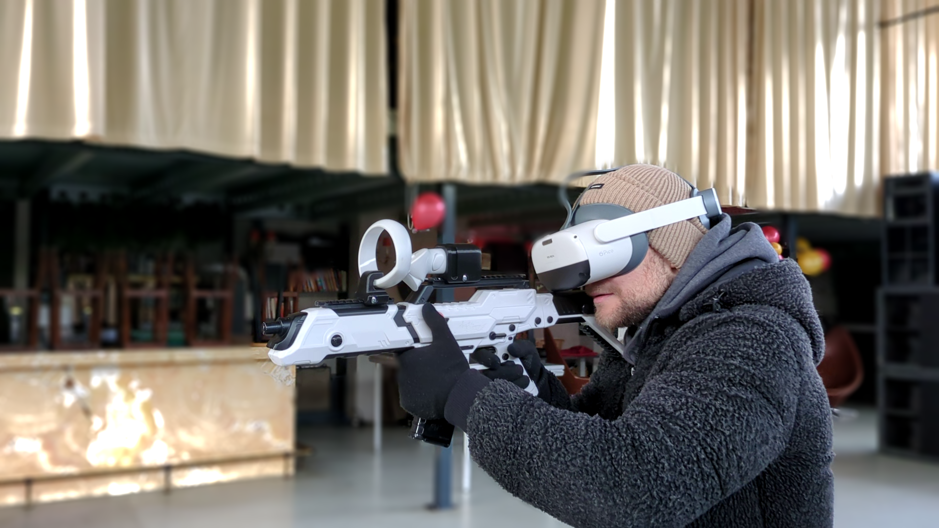 Player with VR headset and controller in a free-roam arena